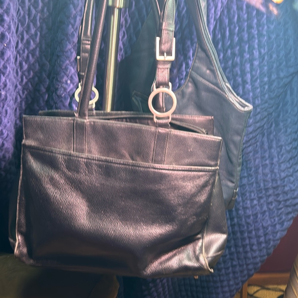 Two different purses, one teal green, the other one black both in decent shape